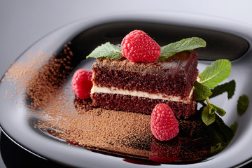 Chocolate cake with raspberry and mint .