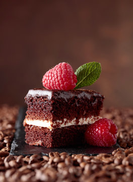 Closeup of chocolate cake with raspberry and mint .