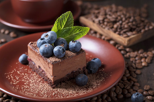 Chocolate cake with blueberries and mint .