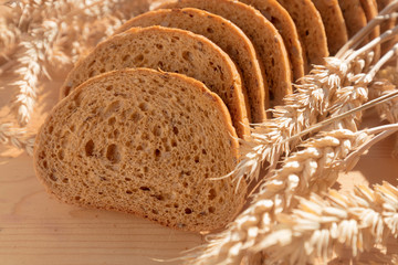 Fototapeta na wymiar Bread with grain on wooden background.