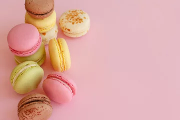 Printed kitchen splashbacks Macarons tasty colorful macarons on trendy pastel pink paper top view. space for text pink, yellow, green, white, brown macaroons. modern food photography concept. luxury catering