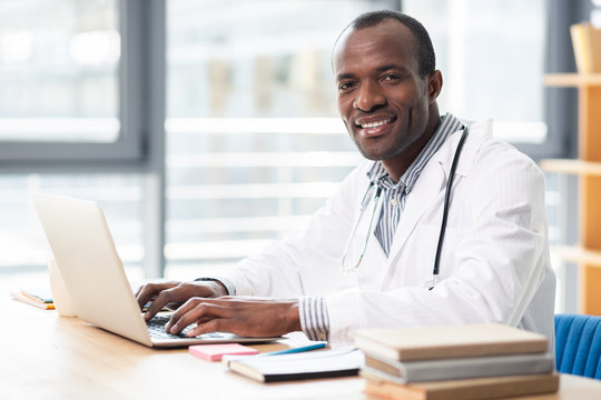 Happy young male person looking at camera