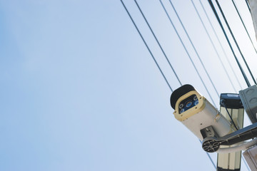 Obraz premium CCTV overhead for security on the road or in town and with under the blue sky background.