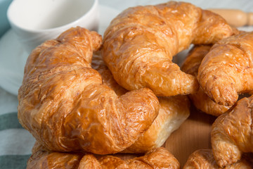 breakfast bakery concept : fresh french croissant on wooden background