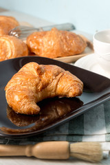 breakfast bakery concept : fresh french croissant on wooden background