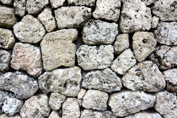 Rock retaining wall background built from local materials without mortar or concrete