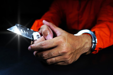 Prisoner in handcuffs and knives as evidence of the case