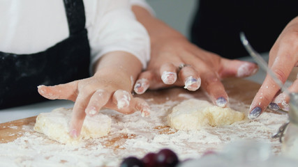 Obraz na płótnie Canvas Woman's hands forming homemade pancakes from dough