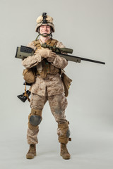 Soldier in camouflage holding rifle