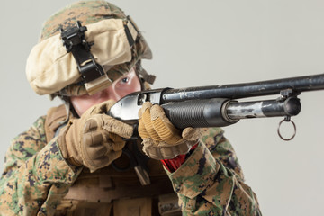 Fototapeta premium Soldier in camouflage holding rifle