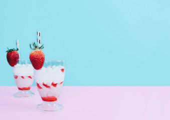 Milkshake with straw and strawberry.