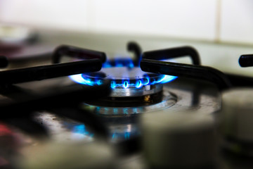 Natural gas burning on kitchen gas stove in the dark. 