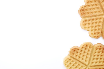 Festive breakfast composition with homemade waffles in the shape of heart for valentine's day.