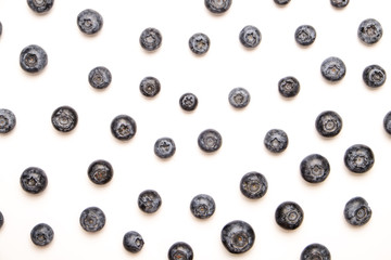 Bunch of fresh organic blueberry berries in seamless pattern on white background. Clean eating concept. Healthy nutritious vegan snack, raw diet. Close up, copy space, top view, flat lay.