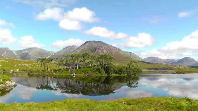 A mountainous landscape reflected in Derryclare Lough, in the Inagh Valley, County Galway, Ireland.
