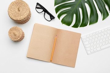 workspace with keyboard, palm leaf and accessories. Flat lay, top view copy space