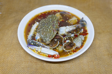 Thai spicy seafood salad with crab and cockle