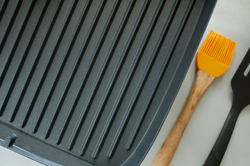 Black electric grill on a gray table.
