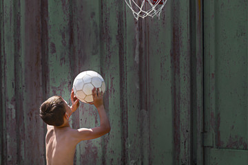 the boy throws the ball into the ring