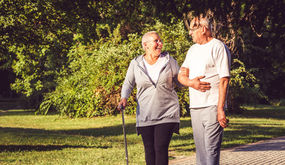 Elderly couple walking through the park.