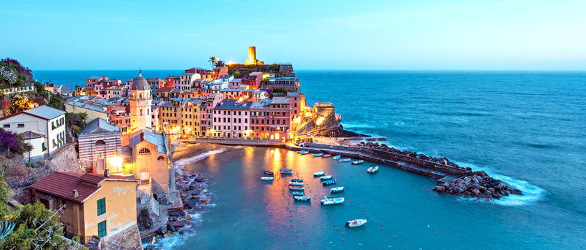 Magical landscape with boats in the bay and colored houses on the rock in Vernazza, Cinque Terre, Italy, Europe