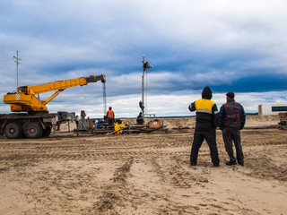 workers on the construction site power line