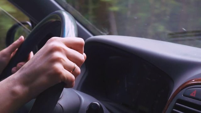 women's hands control the car.close-up