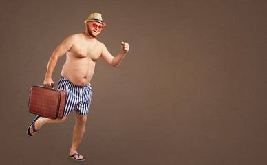 A funny fat man is running with a suitcase for a summer vacation on a background for the text.