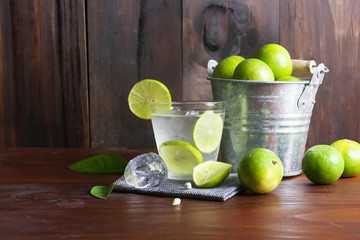 Lime juice or lime lemonade or green lemon with lemon tank on wooden table ,Close up