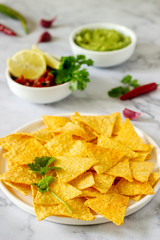 A traditional Mexican snack nachos served with sauces of guacamole, pico de gallo or salsa.