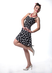 pin up attractive girl in polka dot dress look at you and smile