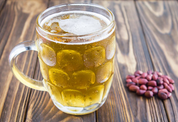 beer and nuts, on a wooden background