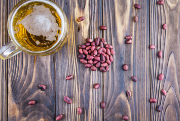 beer and nuts, on a wooden background, top view