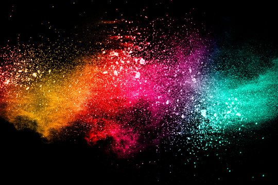 Abstract multi color powder explosion on black background.  Freeze motion of color dust  particles splash. Painted Holi in festival.