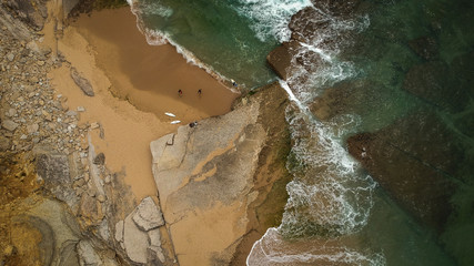 surfer on the beach top view. Drone shot on a beach in a summer day.