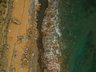Aerial view of sandy beach with waves. Drone photo 