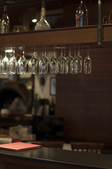 Group of champagne glasses over the bar in pub and restaurant. Soft focus