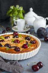 Homemade almond and cherries cake, baked cream with honey and peaches and prunes