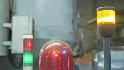 Warning light on a processing machine. Closeup flashing red lamp on machine in toilet paper...