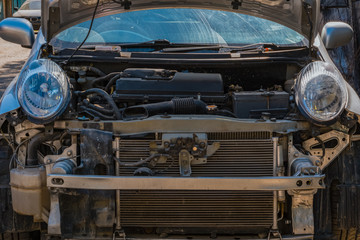 The car in a car-care center. Front part in disassembled condition. repair