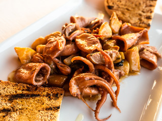 dish of cuttlefish and octopus with toasted bread