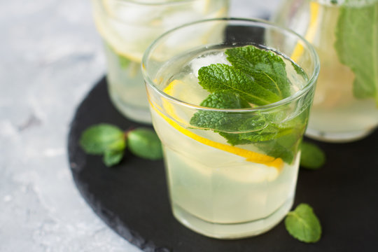 Glass of iced tea with lemon, ginger, mint