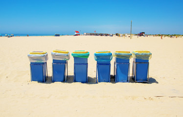 Big blue dust bins at the beach on sunny day