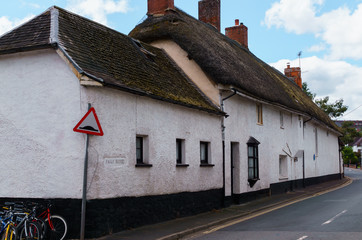 Old houses under thatched roof in the city of Crediton, Devon, United Kingdom June 2, 2018