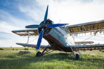 Abandoned old airplane on the field
