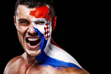 Soccer or football fan with bodyart on face with agression - flag of Croatia.