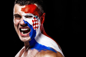 Soccer or football fan with bodyart on face with agression - flag of Croatia.