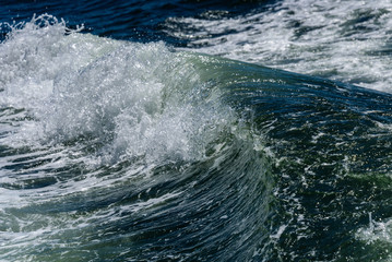 Close up of breaking waves as a nature background, green water, white water and foam
