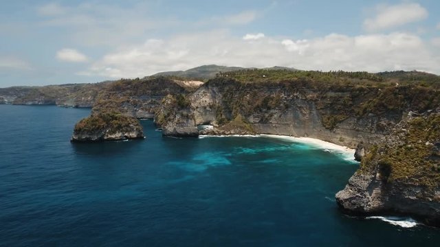Seascape, rocky coast, beach, ocean, blue sea, waves, Nusa Penida, Indonesia. Aerial view Ocean with waves and rocky cliff. 4K video. Travel concept Aerial footage