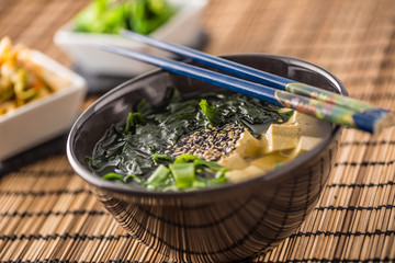 Traditional japanese soup Miso with tofu seaweed chopsticks and young onion